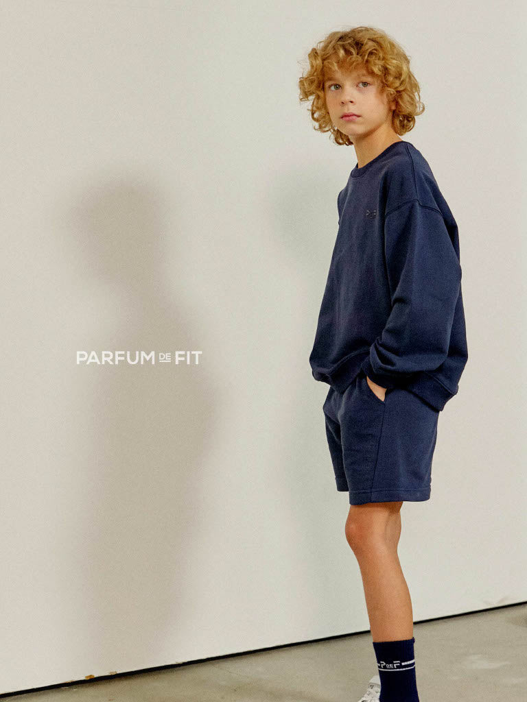 Boy wearing a midnight sweatshirt and shorts set